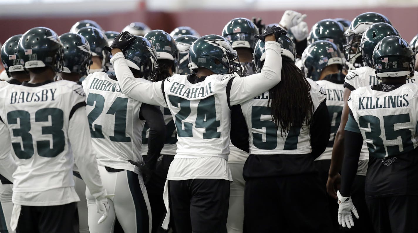 Philadelphia Eagles defensive back Corey Graham (24) reaches around teammates as the team huddles during a practice for the NFL Super Bowl 52 football game Wednesday, Jan. 31, 2018, in Minneapolis. Philadelphia is scheduled to face the New England Patriots Sunday. (AP Photo/Eric Gay) ORG XMIT: MIN2018020119210133