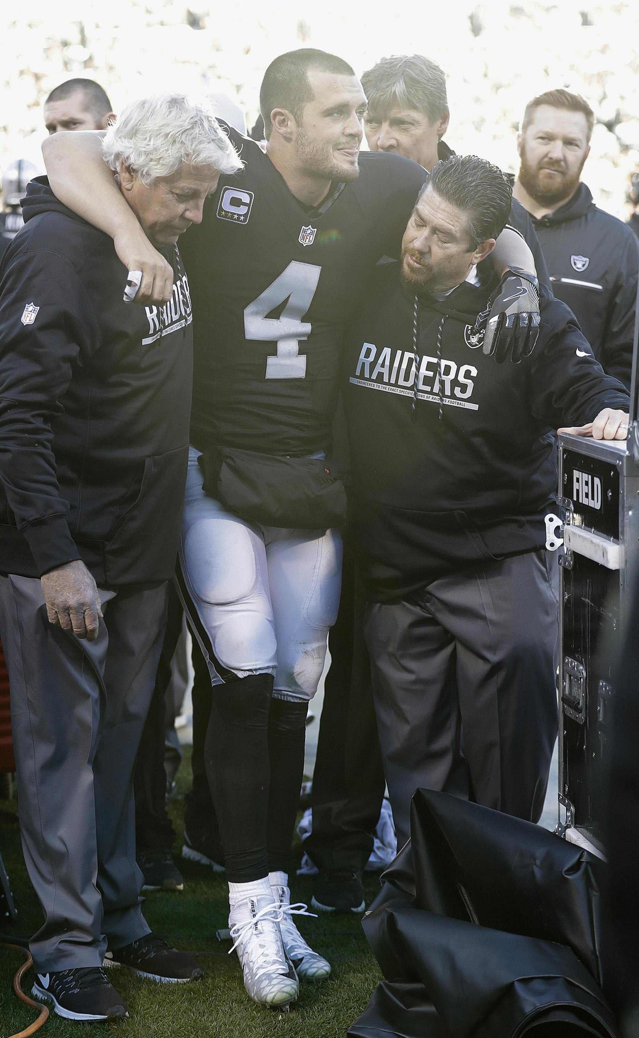 Oakland Raiders quarterback Derek Carr (4) is helped to the sideline during the second half of an NFL football game against the Indianapolis Colts in Oakland, Calif., Saturday, Dec. 24, 2016. (AP Photo/Marcio Jose Sanchez)