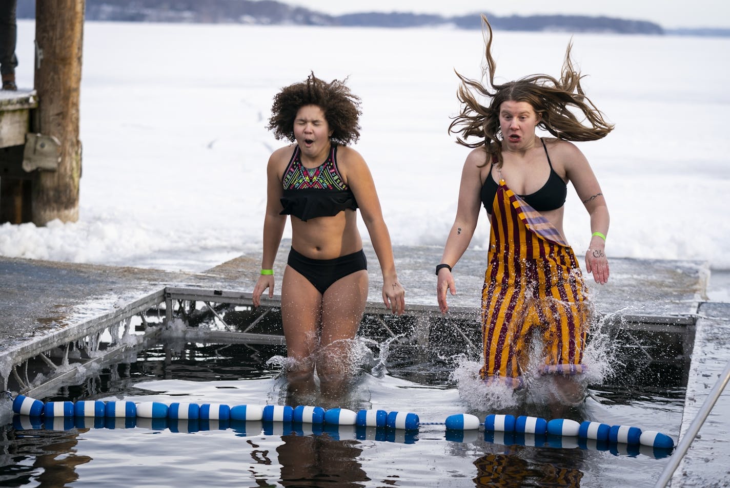 Ella Neal, 13, left, of Hopkins jumped with Sydney Smith, 20, of Tonka Bay during the ALARC Ice Dive.