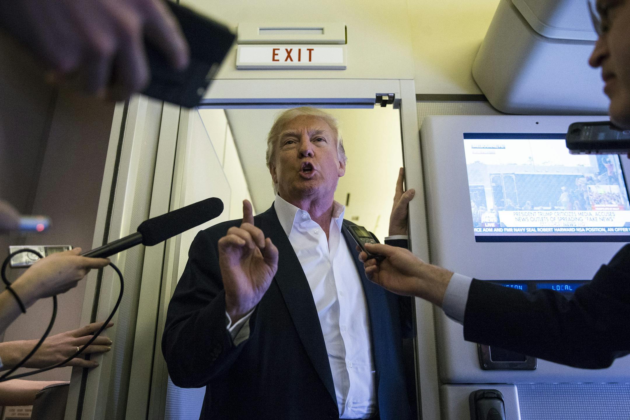 President Donald Trump speaks with reporters in the press cabin of Air Force One before a rally at Orlando Melbourne International Airport, in Melbourne, Fla., Feb. 18, 2017. (Al Drago/The New York Times)
