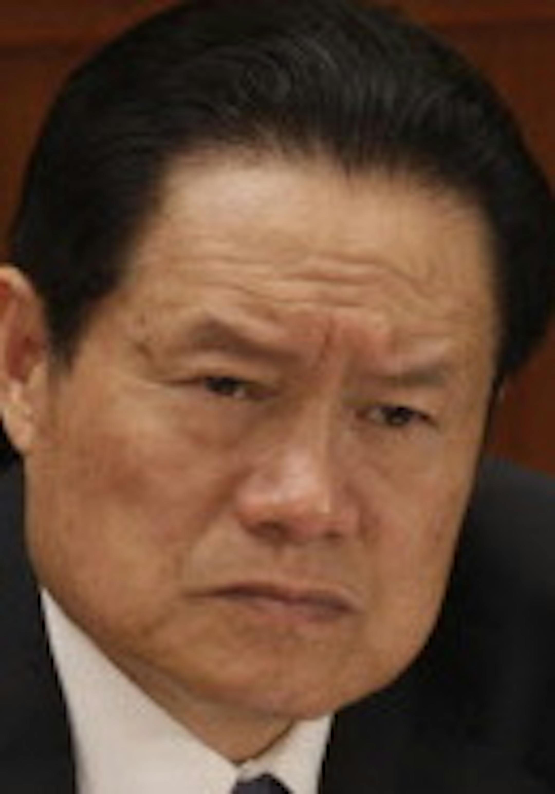 FILE PHOTO: Zhou Yongkang, member of the Standing Committee of the Political Bureau of the Chinese Communist Party (CCP) Central Committee, attends the second plenary session of China's 11th National People's Congress (NPC) in Beijing, China, on Saturday, March 8, 2008. China√≠s corruption watchdog opened a probe into Jiang Jiemin, head of the State-Owned Assets Supervision and Administration Commission and former chairman of China National Petroleum Corp. (CNPC), pursuing the high