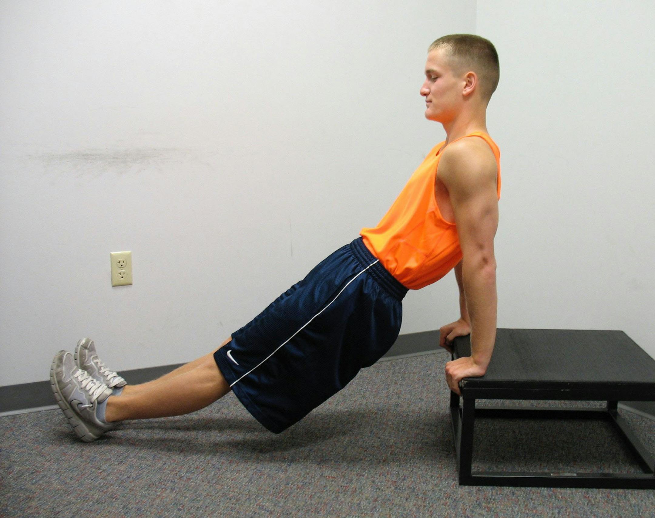 Tricep dips, step 1: With arms and legs extended, bring rear end off the surface. Special to Cox Newspapers.