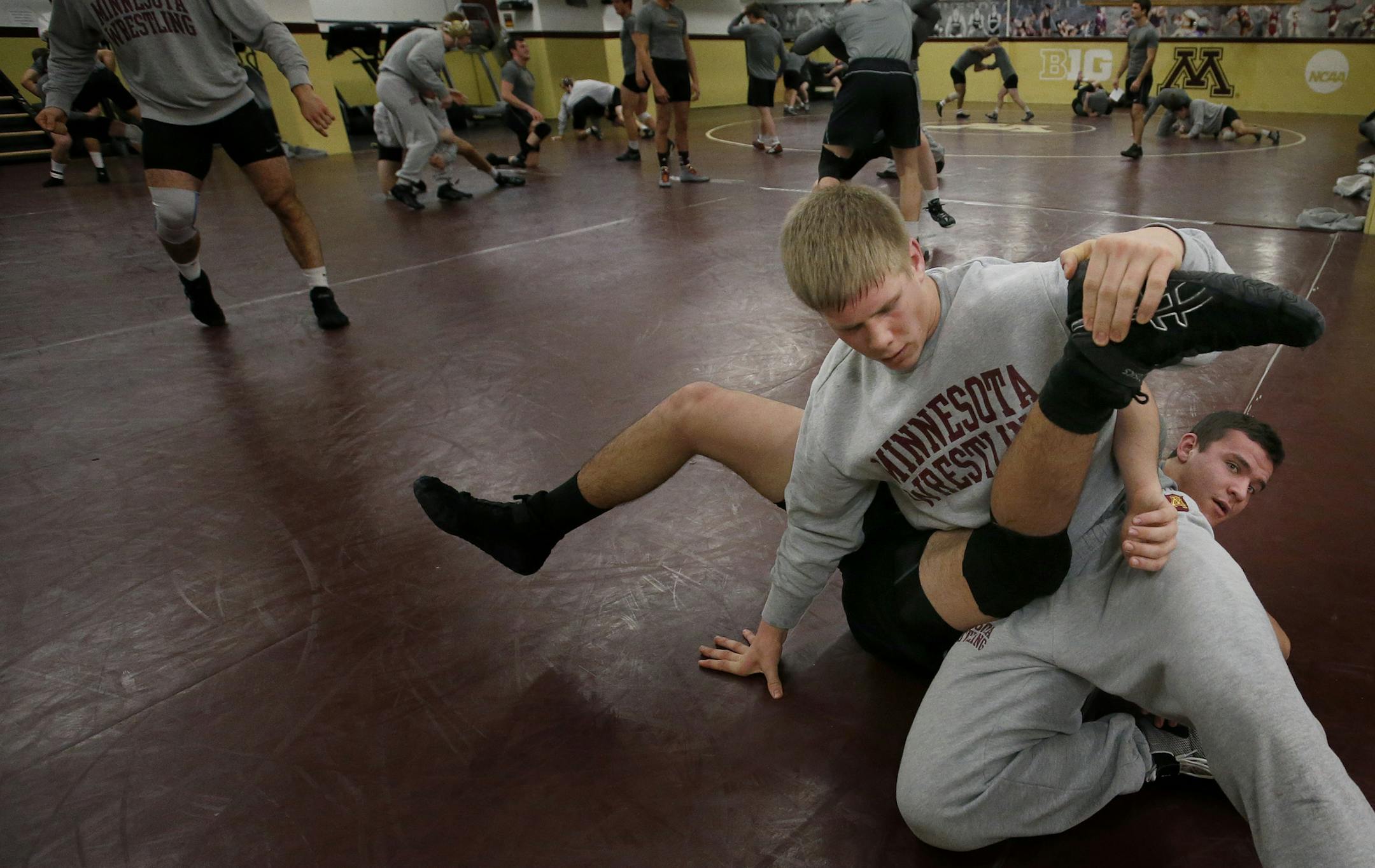 Minnesota wrestlers Chris Pfarr (on top), Tijani Karaborni (on mat) during a practice. ] CARLOS GONZALEZ cgonzalez@startribune.com - December 11, 2014 – Minneapolis, Minn., University of Minnesota Gophers Wrestling - There are four sets of brothers on the team, including a set of twins.