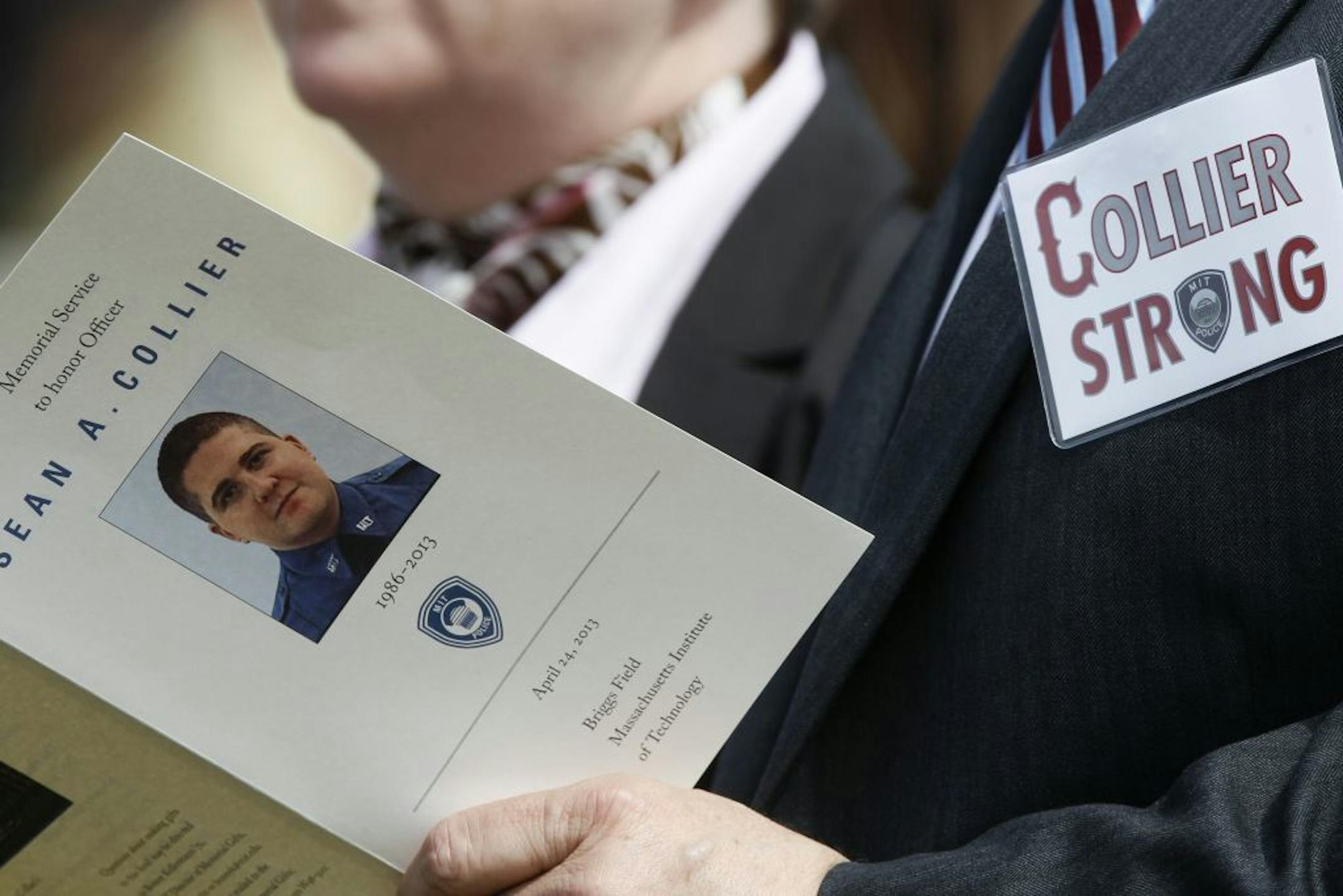 An attendee holds a program during the memorial service for Massachusetts Institute of Technology police officer Sean Collier at Briggs Field on the university's campus in Cambridge, Mass., April 24, 2013. Vice President Joe Biden is scheduled to speak Wednesday at the service in honor of Collier, who was killed during an encounter with Boston Marathon bombings suspects Tamerlan and Dzhokhar Tsarnaev, authorities say.