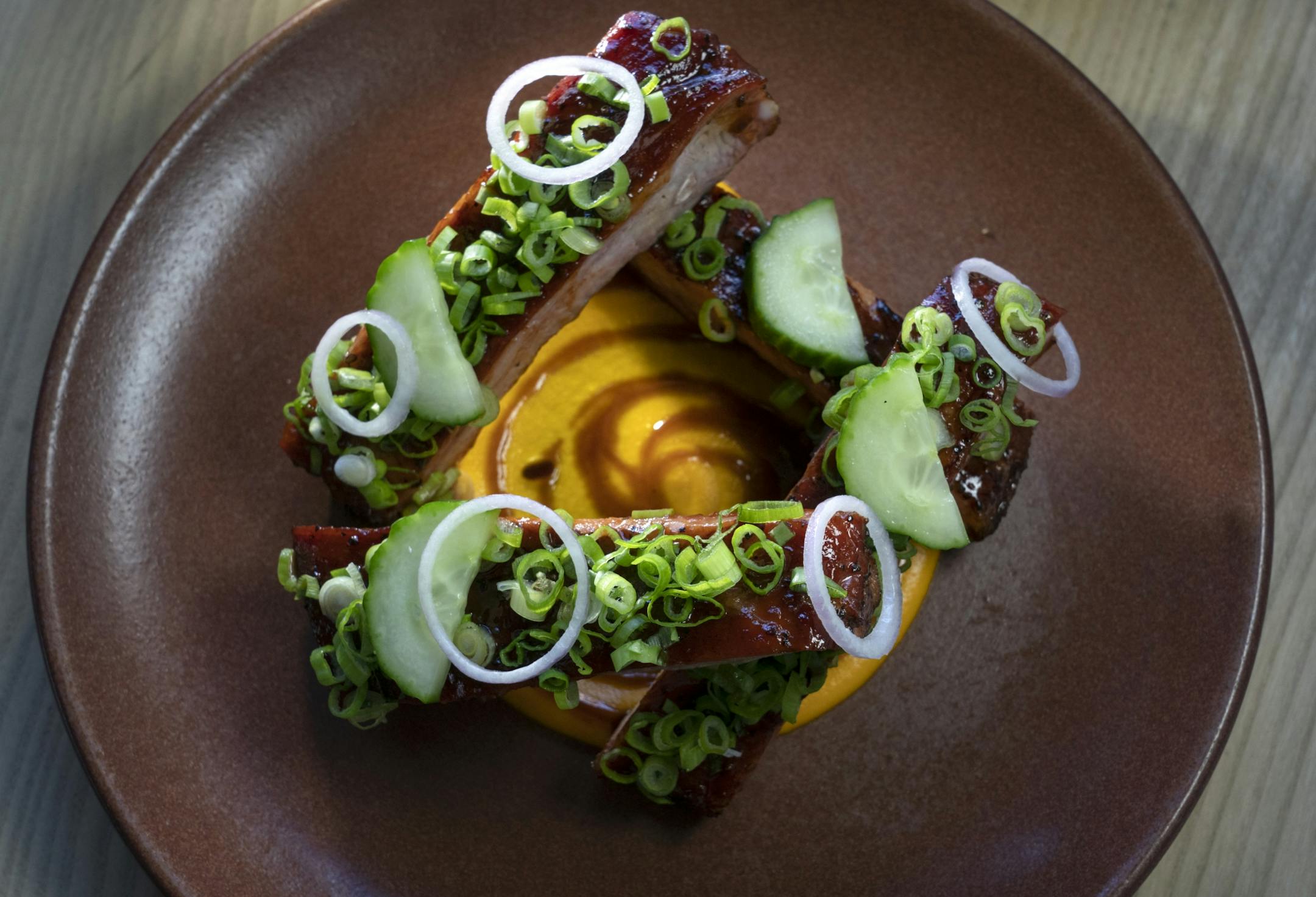 Kansas City Pork Ribs carrot puree, tamarind, shallot, cucumber.