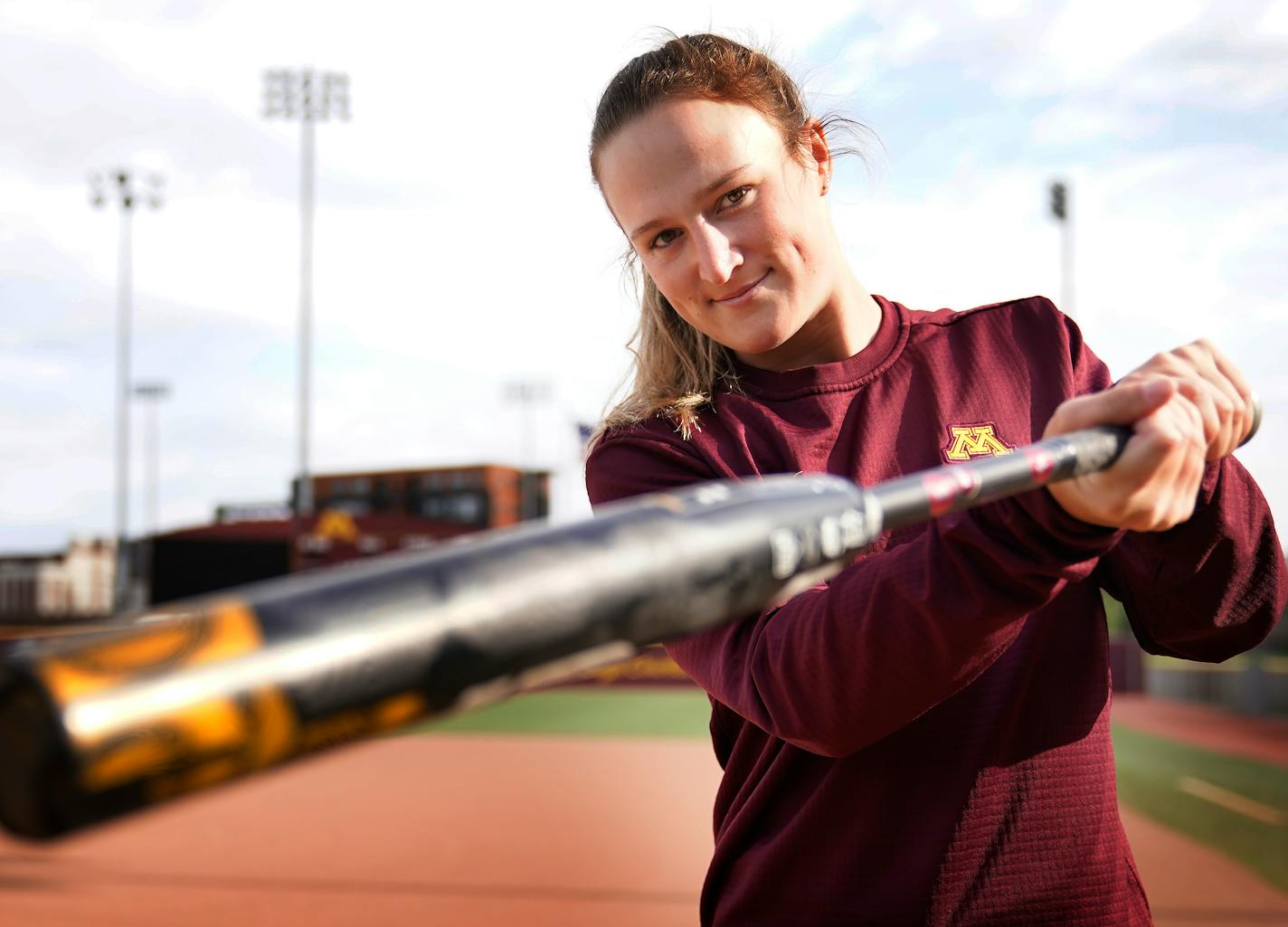 University of Minnesota women's softball left fiedler Natalie DenHartog from Hopkins, who has 18 homers going into the Big 10 tourney, poses for a portrait at Jane Sage Cowles Stadium before practice Tuesday, May 10, 2022 in Minneapolis, Minn. ]