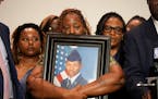 Chantimekki Fortson, mother of Roger Fortson, a U.S. Navy airman, holds a photo of her son during a news conference with Attorney Ben Crump, Thursday,