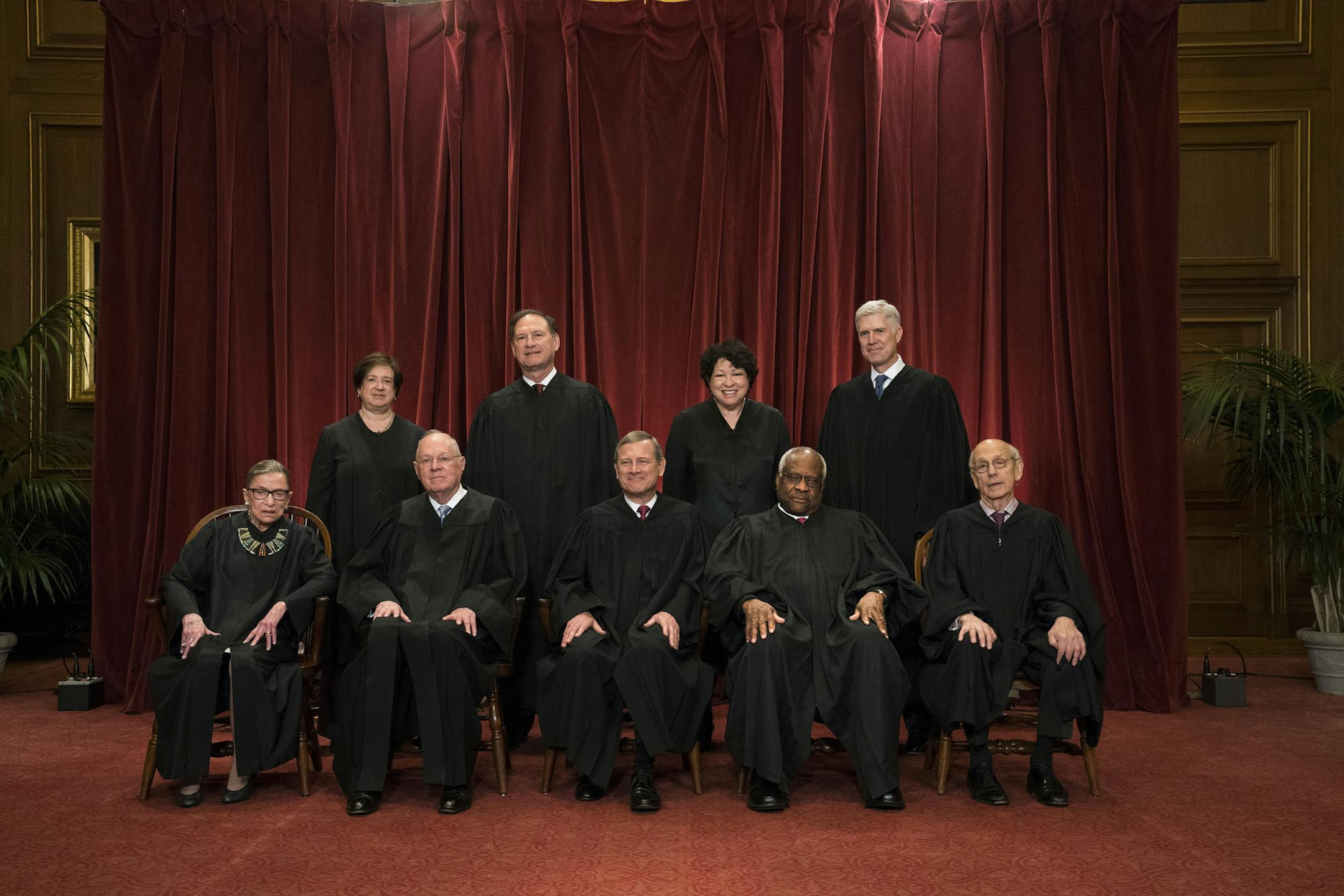FILE-- The justices of the U.S. Supreme Court sit for a group portrait in Washington, June 1, 2017. The Supreme Court, which was shorthanded and slumbering for more than a year after the death of Justice Antonin Scalia, is returning to the bench on Oct. 2 with a far-reaching docket that renews its central role in American life. Front row, from left: Justice Ruth Bader Ginsburg, Justice Anthony Kennedy, Chief Justice John Roberts, Justice Clarence Thomas, and Justice Stephen Breyer. Back row, fro