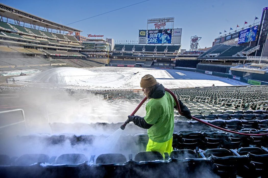 Andrew Hall used hot water to remove snow from seats before the 2018 home opener.