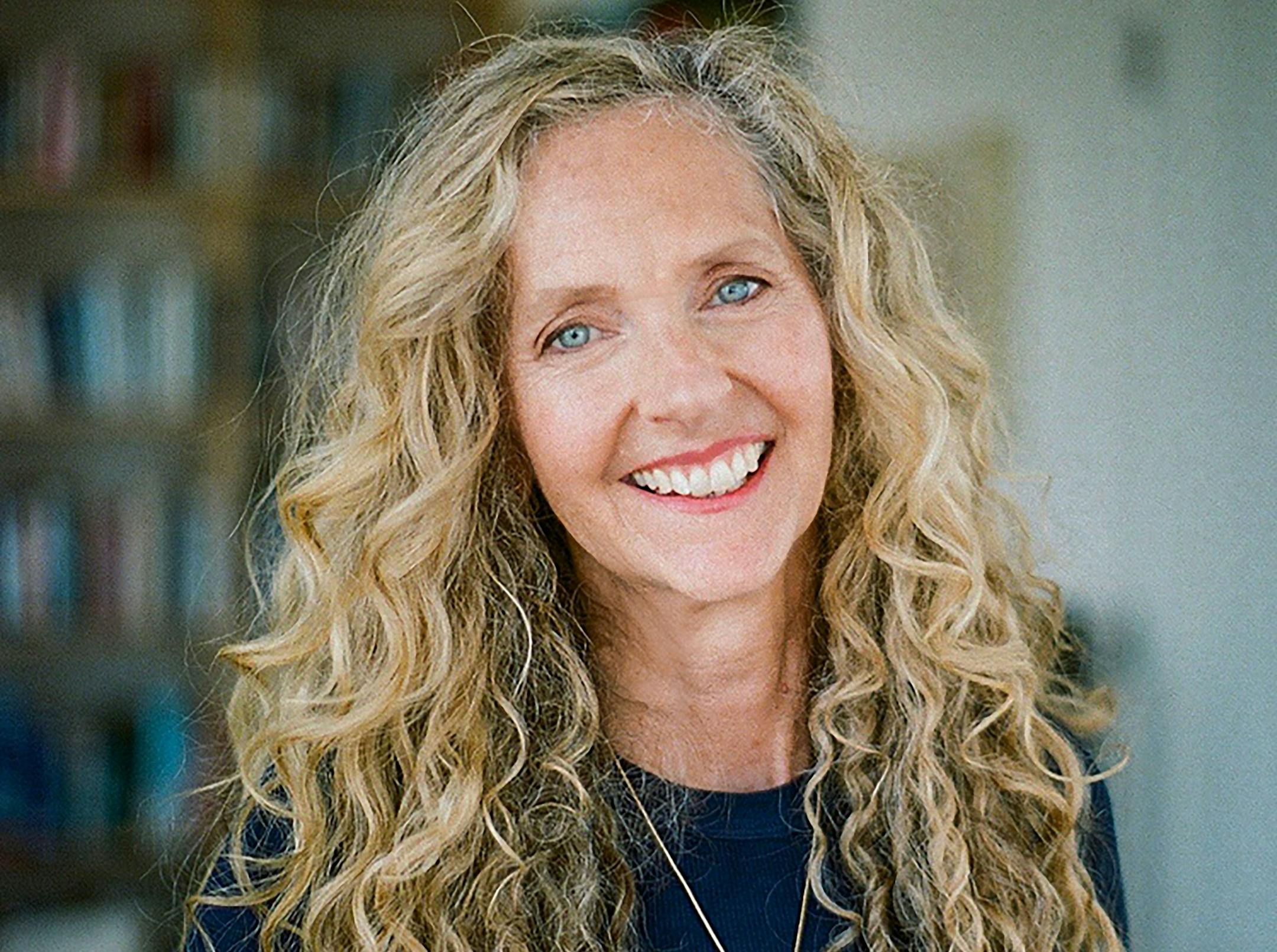 photo of author Lily King, with bookcases in the background