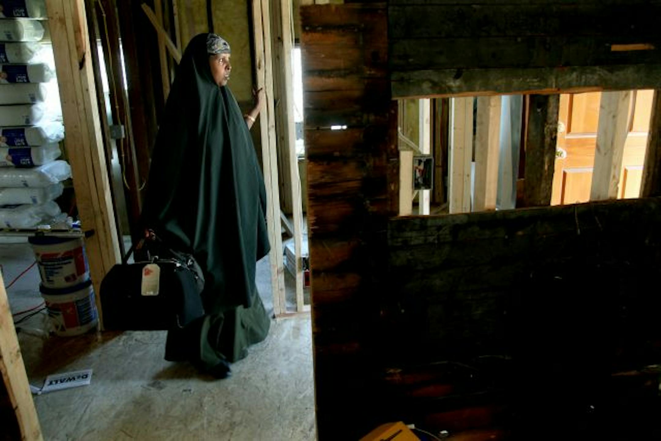 Shamso Mohamed made her way through what will be their new home on Minneapolis' near south side. The home will have a large room for Sulebaan that will have a wheelchair accessible bathroom and a mechanical device that will help move him.