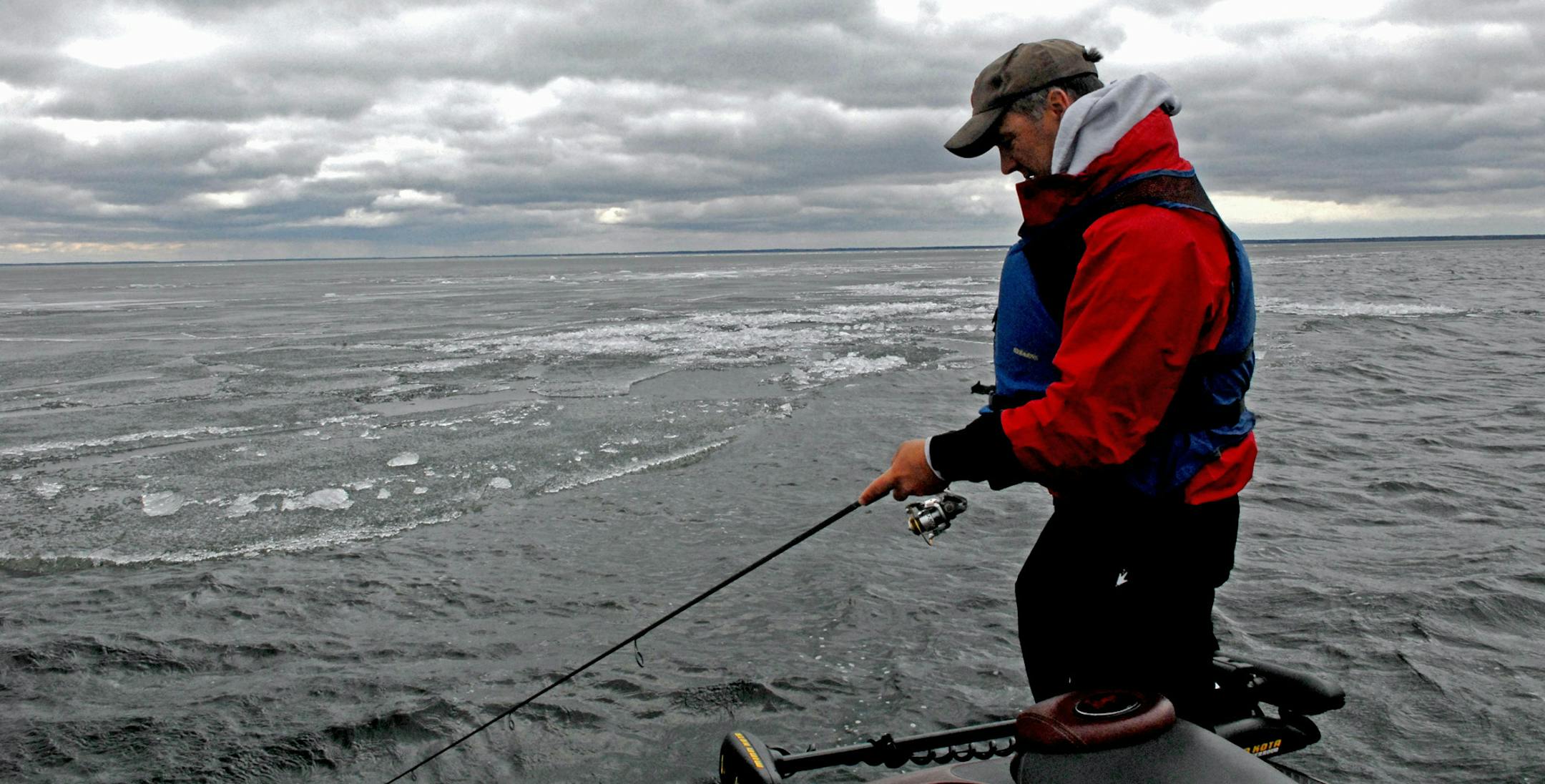 John Heroff of Stillwater tried his luck for walleyes, following the edge of a massive sheet of ice that still covered most of Lake Winnibigoshish on opening day last May. ORG XMIT: MIN1305111154110859
