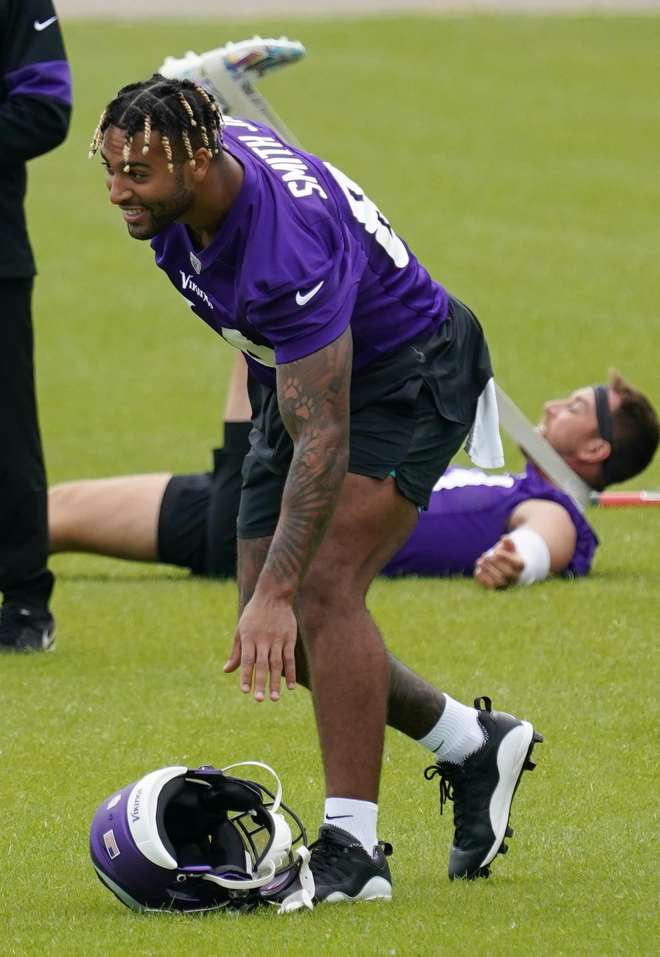 Minnesota Vikings tight end Irv Smith (84) laughed as he grabbed his helmet.