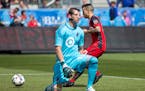 Toronto FC's Sebastian Giovinco, rear, collects the ball after slotting a penalty past Minnesota United goalkeeper Bobby Shuttleworth during the first