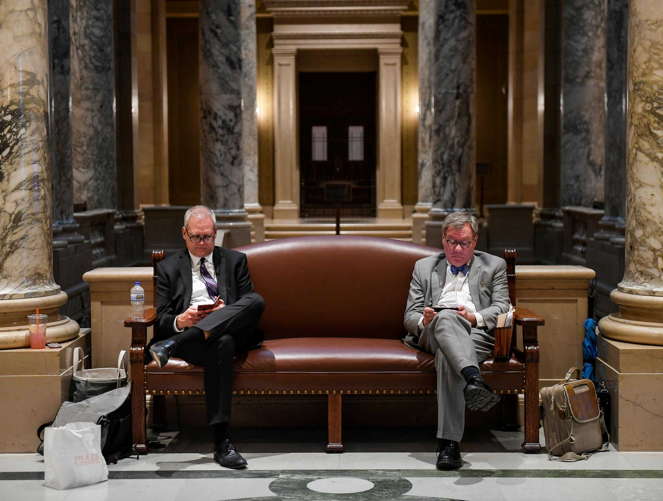 Brian Rice, right, a pension lobbyist, and Doug Anderson, director of the Public Employees Retirement Association, checked their phones during a recess in Tuesday night's legislative special session. ] AARON LAVINSKY &#xef; aaron.lavinsky@startribune.com Minnesota lawmakers are back at the Capitol on Wednesday, to finalize a budget deal cut by Gov. Mark Dayton and Republican leaders in a brief special session. Photographed Tuesday, May 23, 2017 at the State Capitol in St. Paul, Minn.