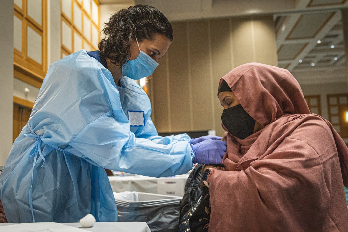 People receive the Moderna COVID-19 vaccination at the Minneapolis convention center.