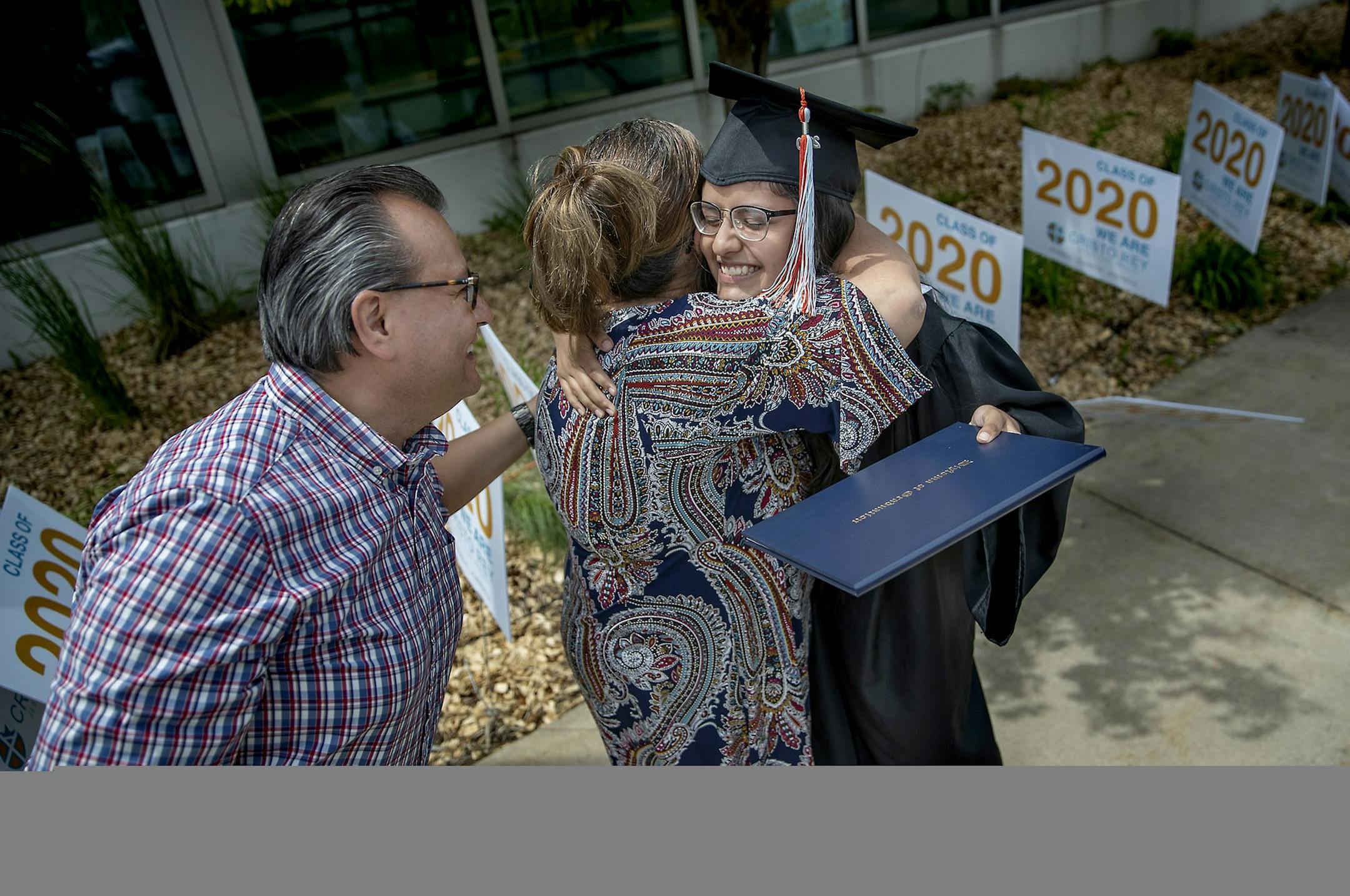 Cristo Rey Jesuit High School graduate Maria Medel became emotional as she was hugged by her parents, Elvia Huitron-Romero and Rod Medel, during their drive-thru commencement celebration, Saturday, June 6, 2020 in Minneapolis, MN. The school, located in the heart of the unrest, only had four windows broken. Cristo Rey graduated a class of 124. ] ELIZABETH FLORES • liz.flores@startribune.com