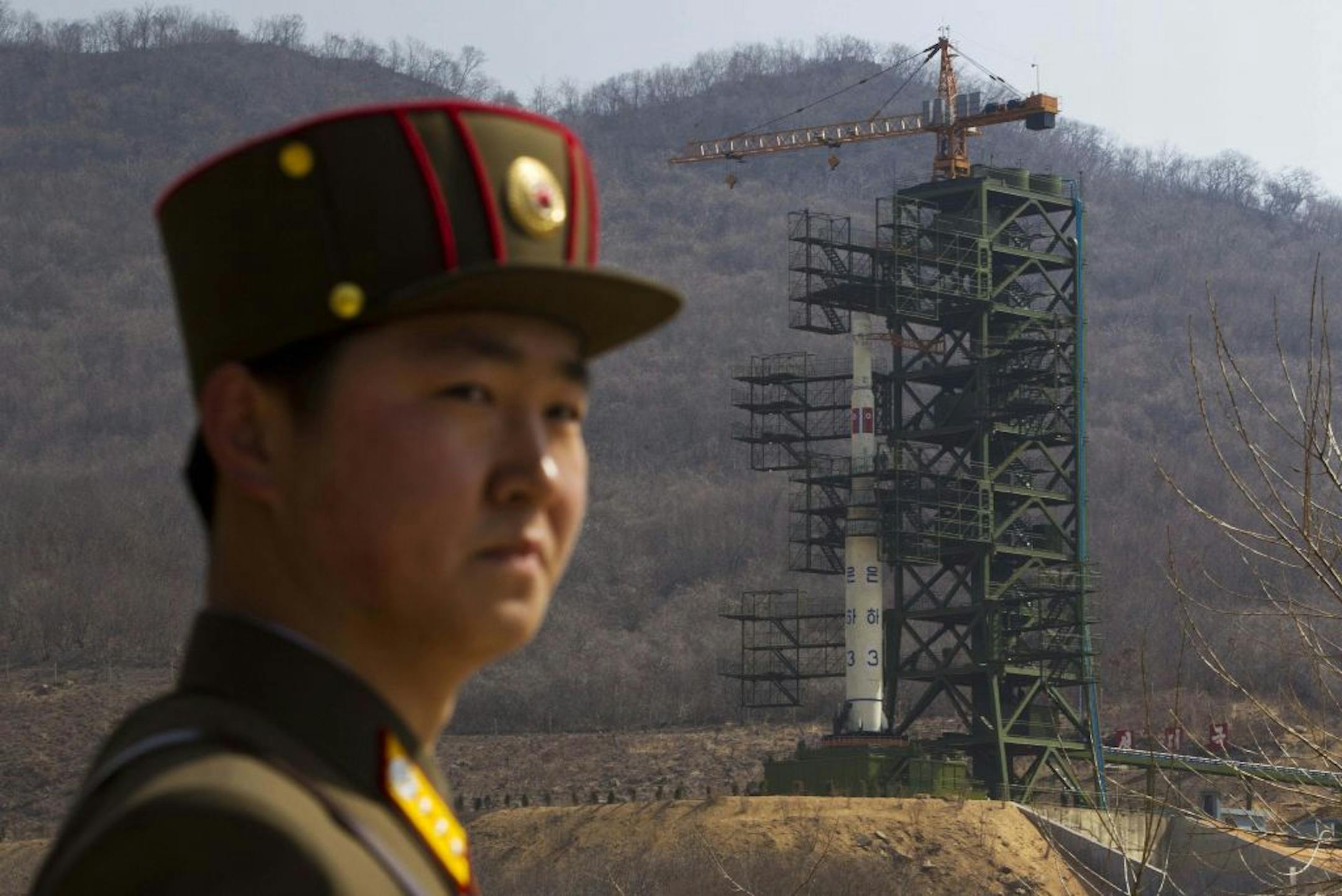 FILE - In this April 8, 2012 file photo, a North Korean soldier stands in front of the country's Unha-3 rocket at a launching site in Tongchang-ri, North Korea. North Korea fired the long-range rocket early Friday, South Korean and U.S. officials said, defying international warnings against moving forward with a launch widely seen as a provocation.