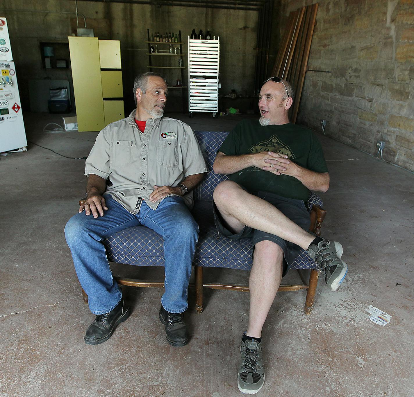 Kevin Breeggemann, owner of the 150-year-old Jordan Brewery, left, and Tim Roets sat where they had to evacuate the building last year due to a mudslide, Friday, June 26, 2015 in Jordan, MN. The disaster occurred only months before the place was set to open as a microbrewery/bar, the centerpiece of a downtown revitalization project. ] (ELIZABETH FLORES/STAR TRIBUNE) ELIZABETH FLORES &#x2022; eflores@startribune.com