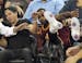 Cleveland Cavaliers' LeBron James falls into Ellie Day, wife of PGA Tour golf player Jason Day, at left, during the second half of an NBA basketball g