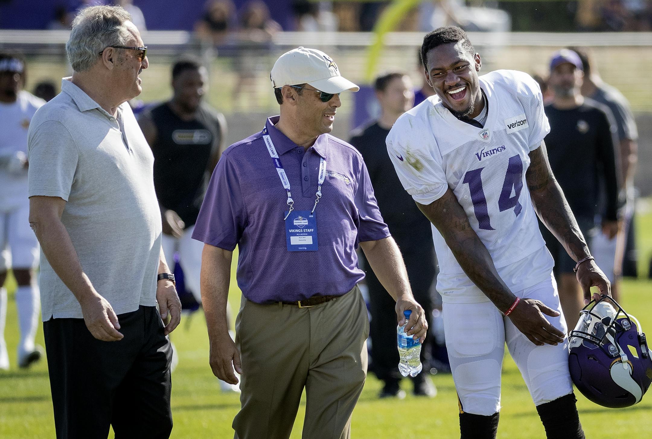 Minnesota Vikings receiver Stefon Diggs (14) was greeted by team owners Zygi Wilf and Mark Wilf after practice on Tuesday. Diggs signed a 5-year extension with the team.