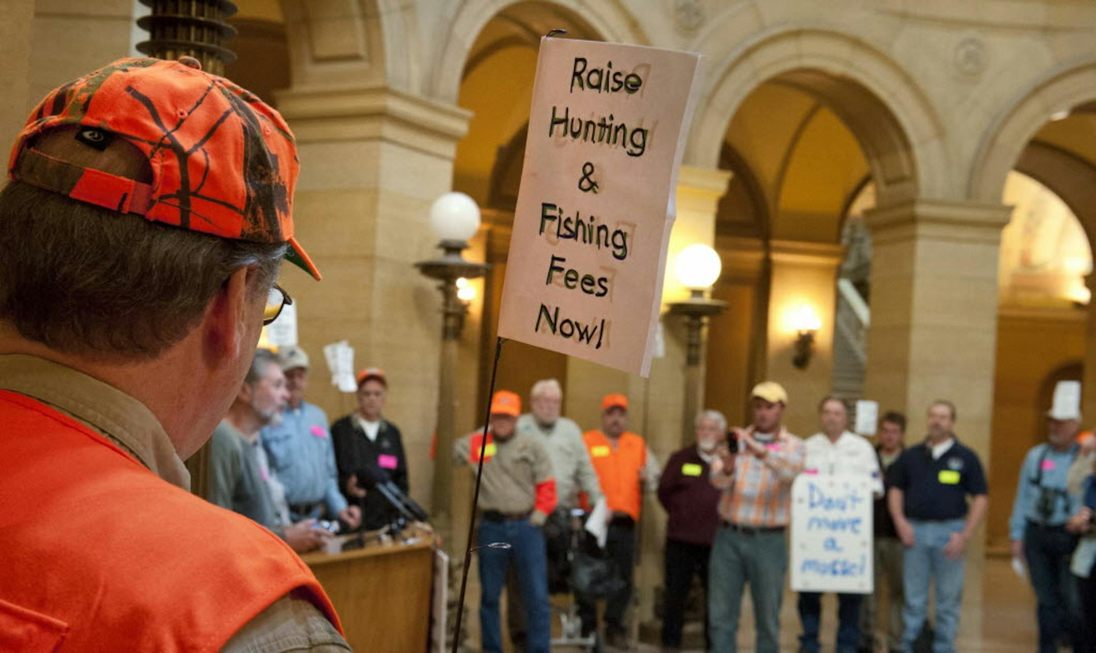 Hunters and anglers gathered in the State Capitol rotunda on Monday in support of raising hunting and fishing fees.