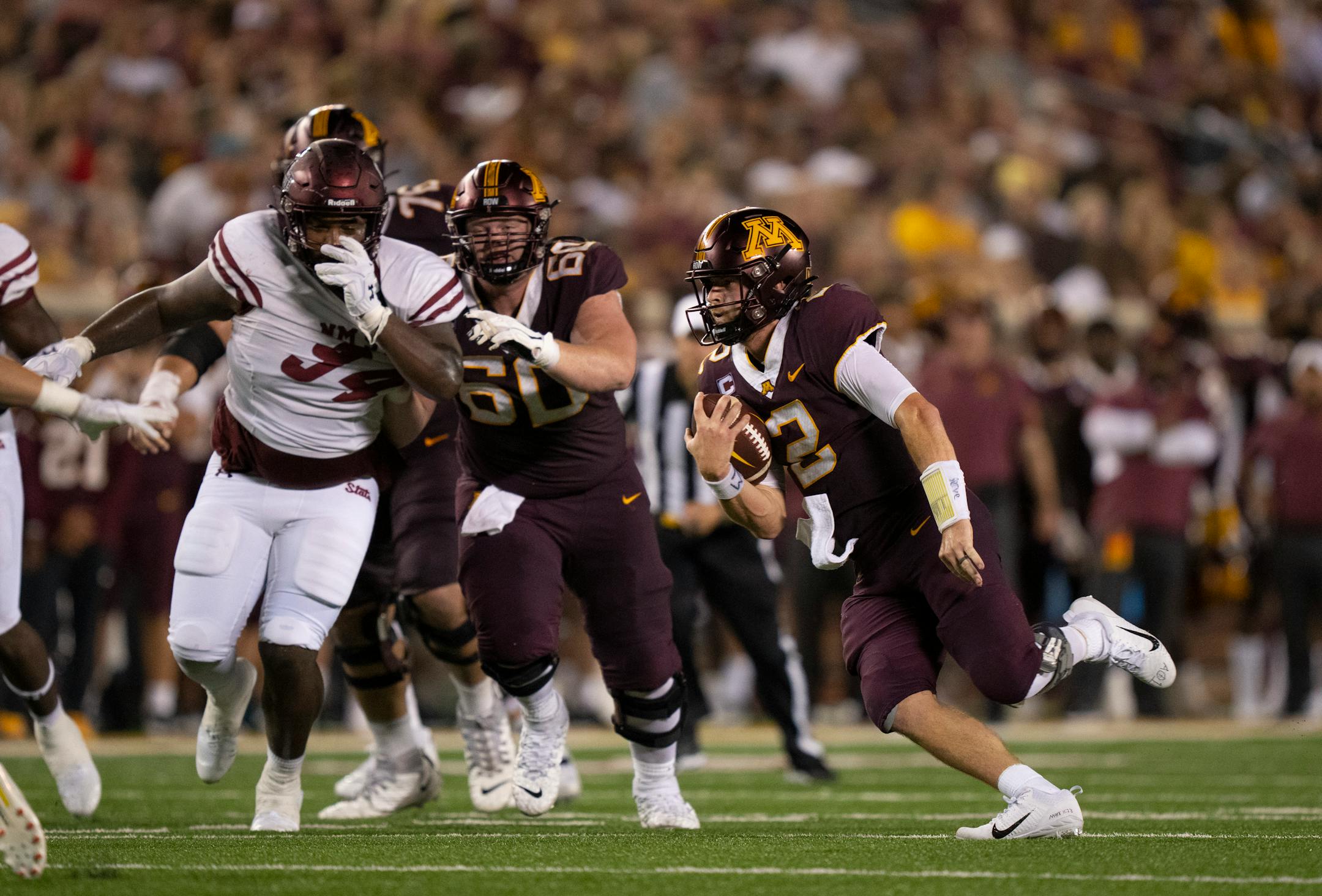 Minnesota Golden Gophers quarterback Tanner Morgan (2) ran for a first down in the third quarter.
