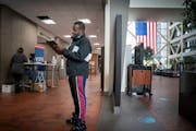 Victor Gaten filled out his ballot application Wednesday at the Hennepin County Government Center. ] GLEN STUBBE • glen.stubbe@startribune.com Wedne