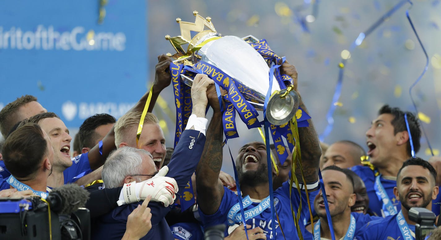 Leicester&#xed;s Wes Morgan lifts the trophy as Leicester City celebrate becoming the English Premier League soccer champions at King Power stadium in Leicester, England, Saturday, May 7, 2016.(AP Photo/Matt Dunham)