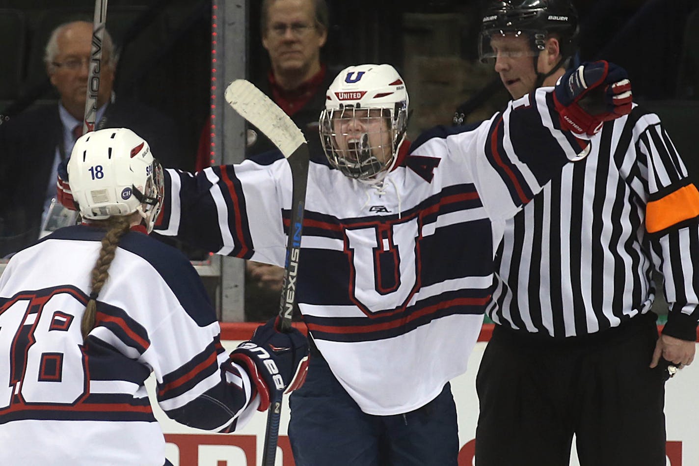 St. Paul United's Joie Phelps (right) celebrated her teammates, including Samantha Burke (left) after scoring a first period goal during her school's 4-3 victory over Warroad in the state girls' hockey tournament.