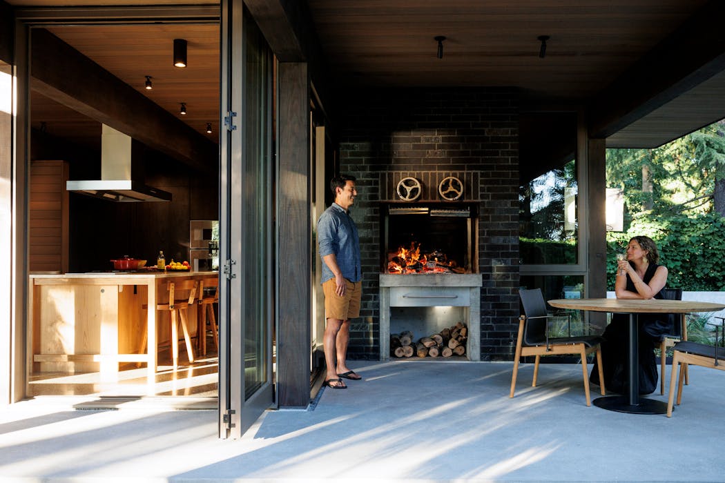 Sonya Schneider and Stuart Nagae in the new indoor/outdoor kitchen extension of their home.