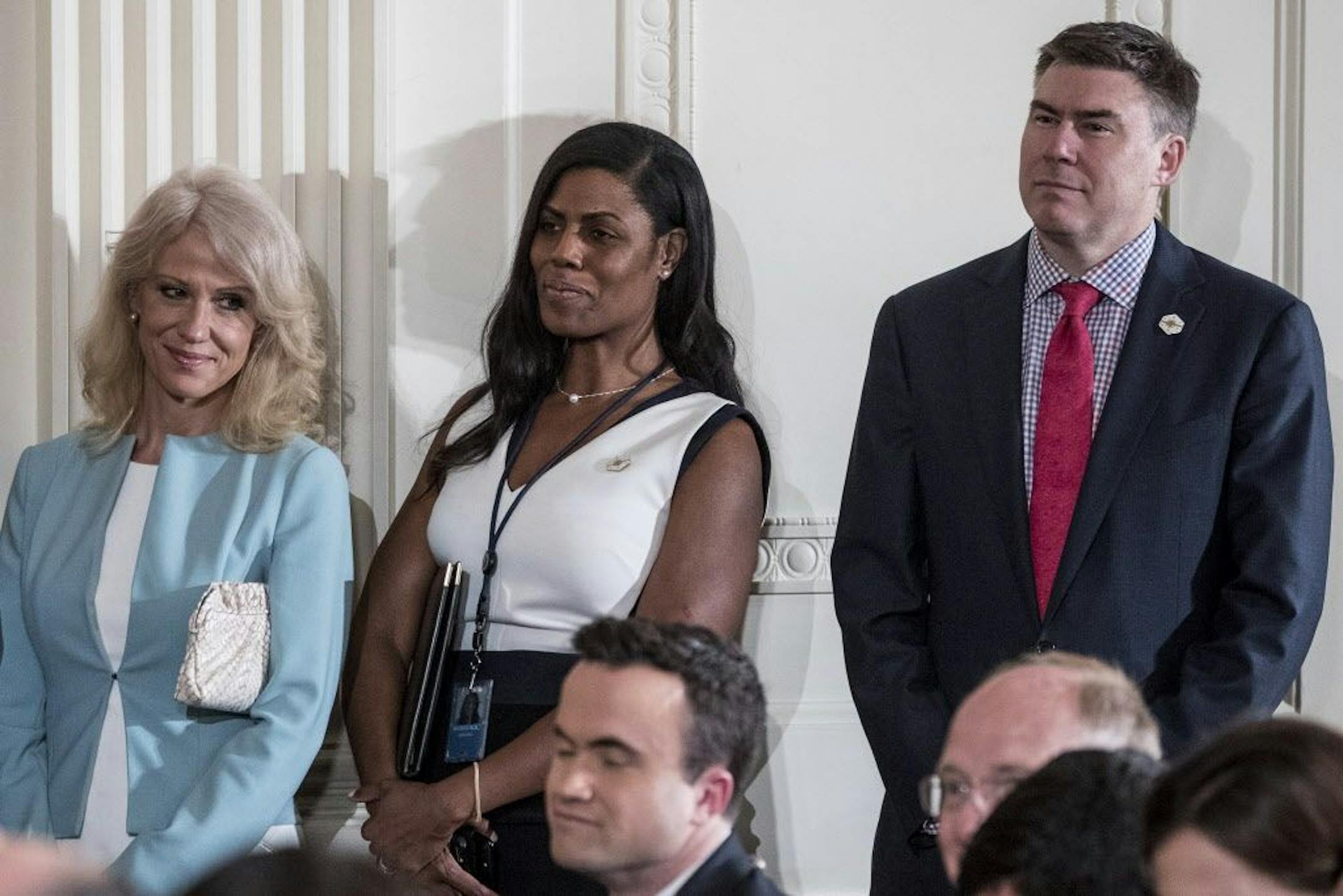 In this photo taken April 20, 2017, from left, Counselor to the President Kellyanne Conway, White House Director of communications for the Office of Public Liaison Omarosa Manigault, and then-White House Communications Director Mike Dubke, attend a news conference in the East Room of the White House in Washington.