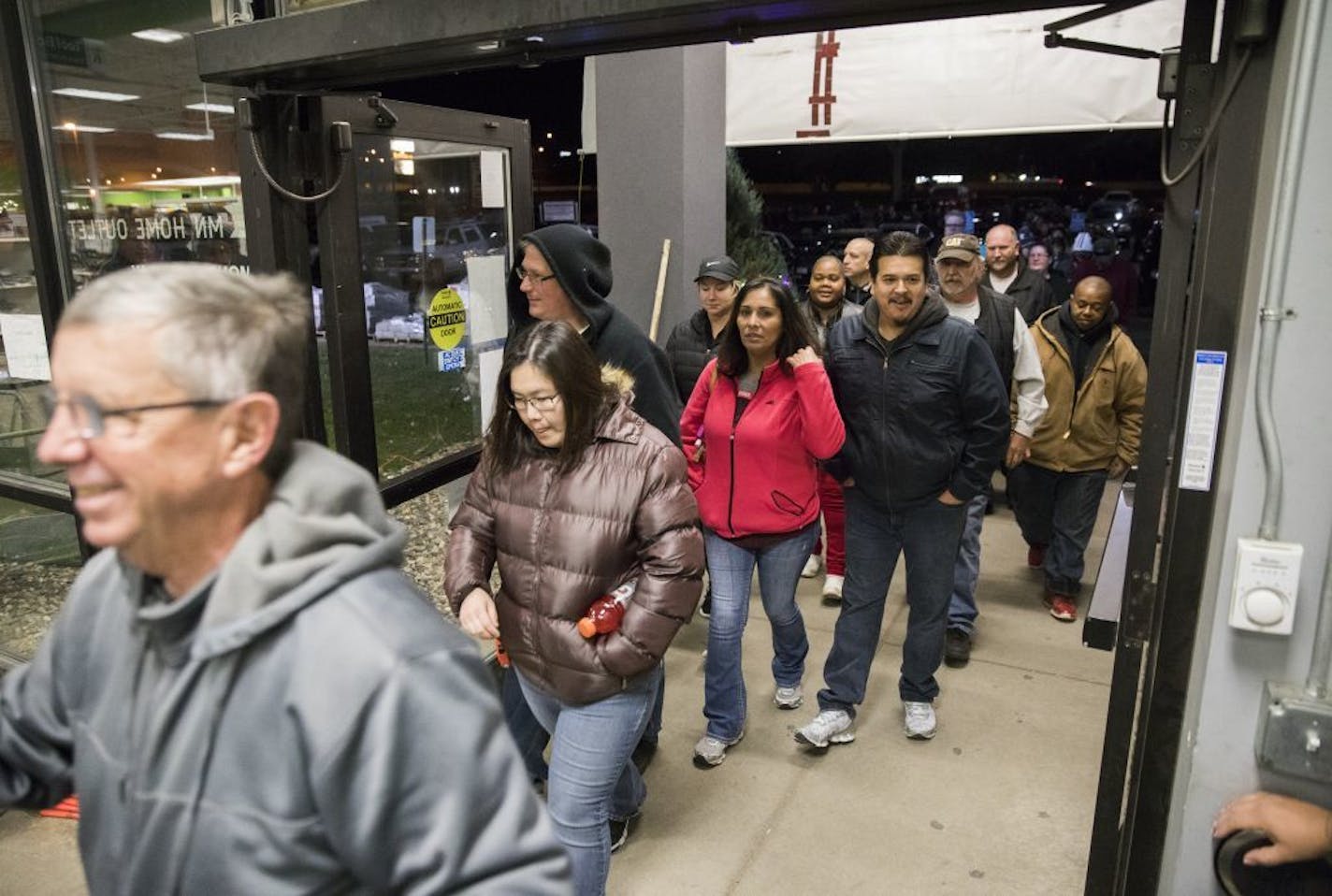 The first rush of customers enters MN Home Outlet at 6 a.m. on Black Friday in Burnsville.