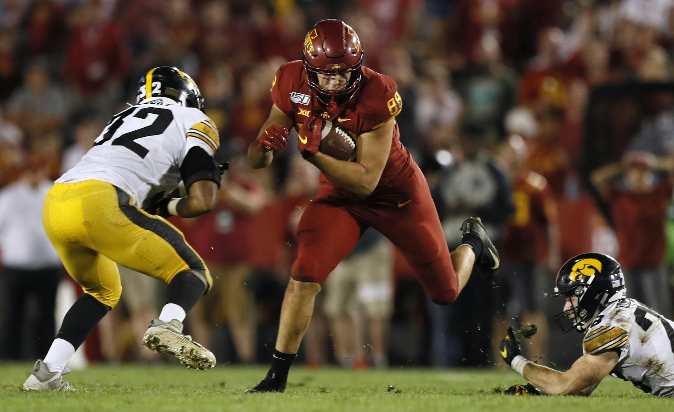 Iowa State tight end Charlie Kolar catches a pass between Iowa defenders Djimon Colbert, left, and Jack Koerner during the second half of an NCAA college football game Saturday, Sept. 14, 2019, in Ames, Iowa. Iowa won 18-17. (AP Photo/Charlie Neibergall)