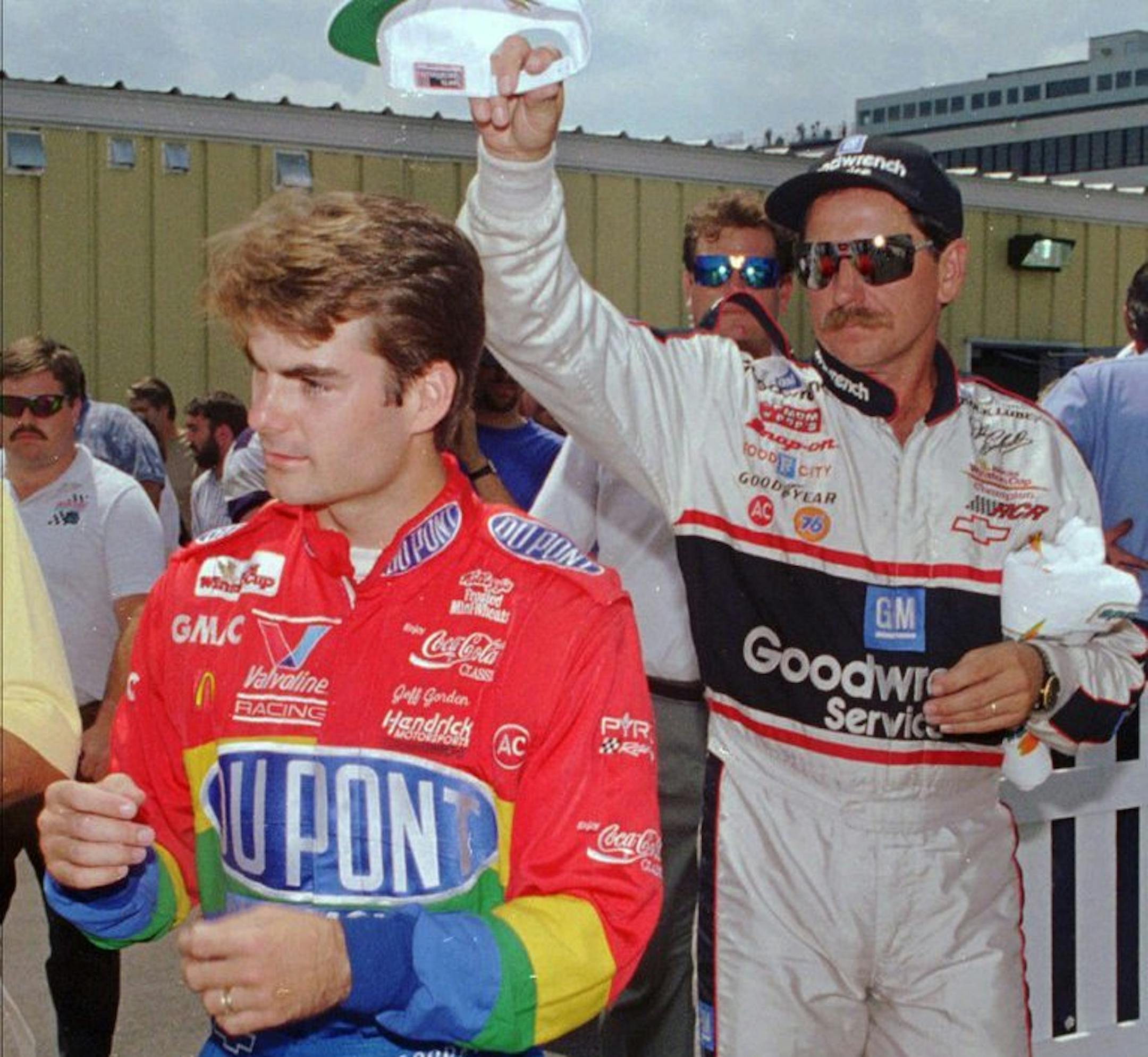 Winston Cup race driver Dale Earnhardt, right, sneaks up behind racer Jeff Gordon Friday, July 7, 1995, in Loudon, N.H., to put a Gatorade hat on him after photo op at New Hampshire International Speedway. Gordon couldn't wear the hat for the photo op because of sponsorship reasons. (AP Photo/Jim Cole)