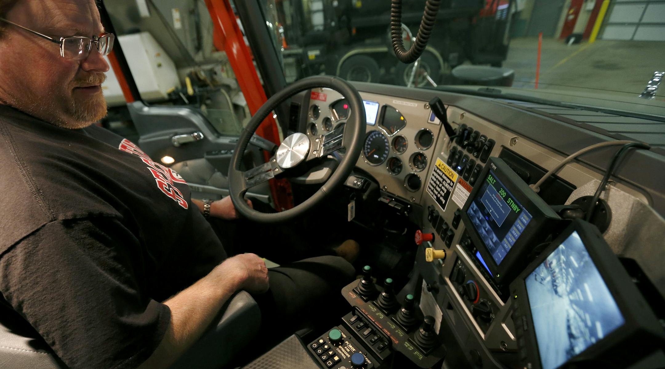 Kris Holzknecht demonstrated the computer and monitoring system of a new Anoka County snowplow truck on Tuesday.