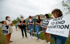 Abortion opponents pray and protest outside of a Whole Women’s Health of North Texas, Oct. 1, in McKinney, Texas. 