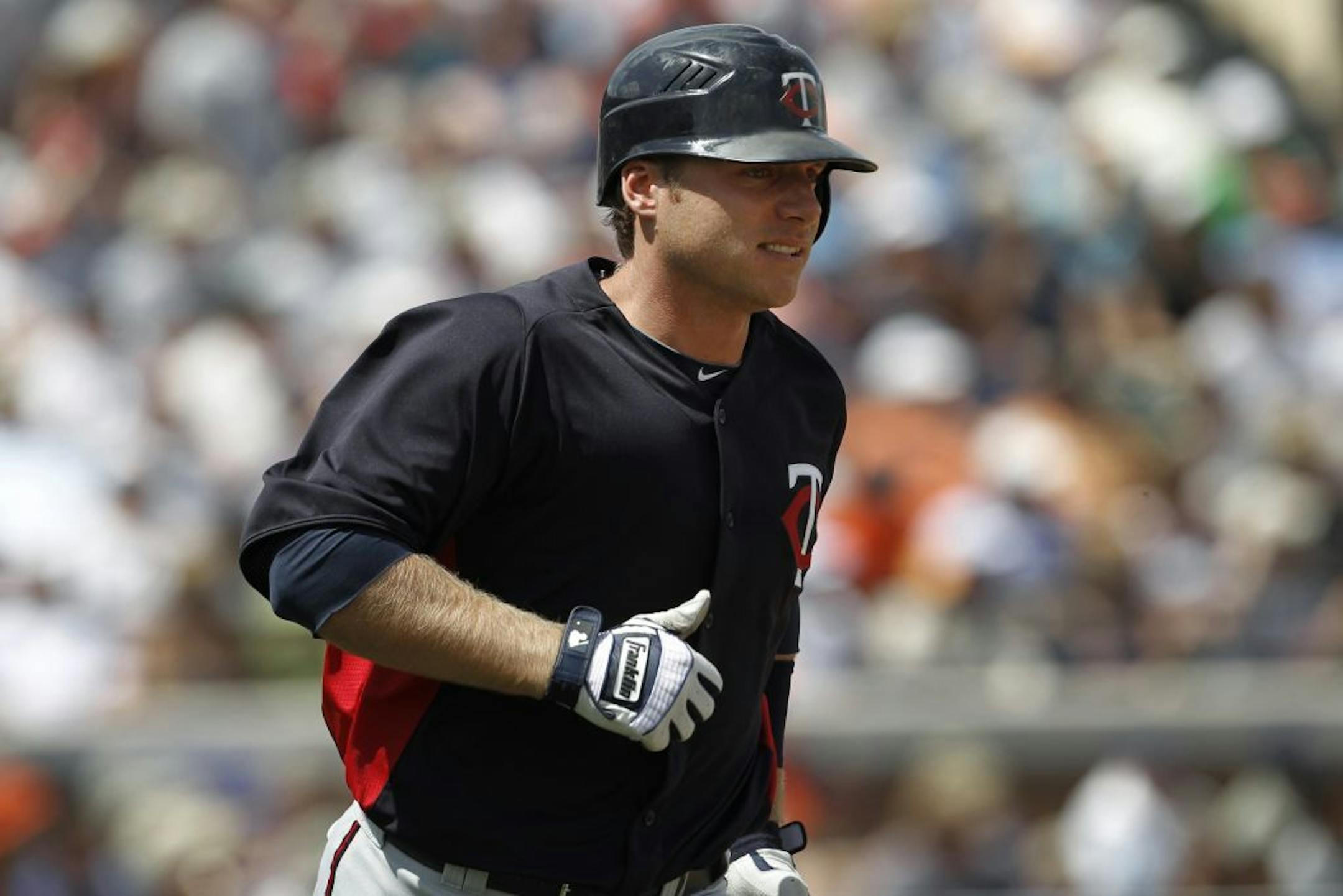 Minnesota Twins' Luke Hughes runs the bases after hitting a two-run home run against the Detroit Tigers in the second inning during a spring training baseball game in Lakeland, Fla., Wednesday, March 21, 2012.