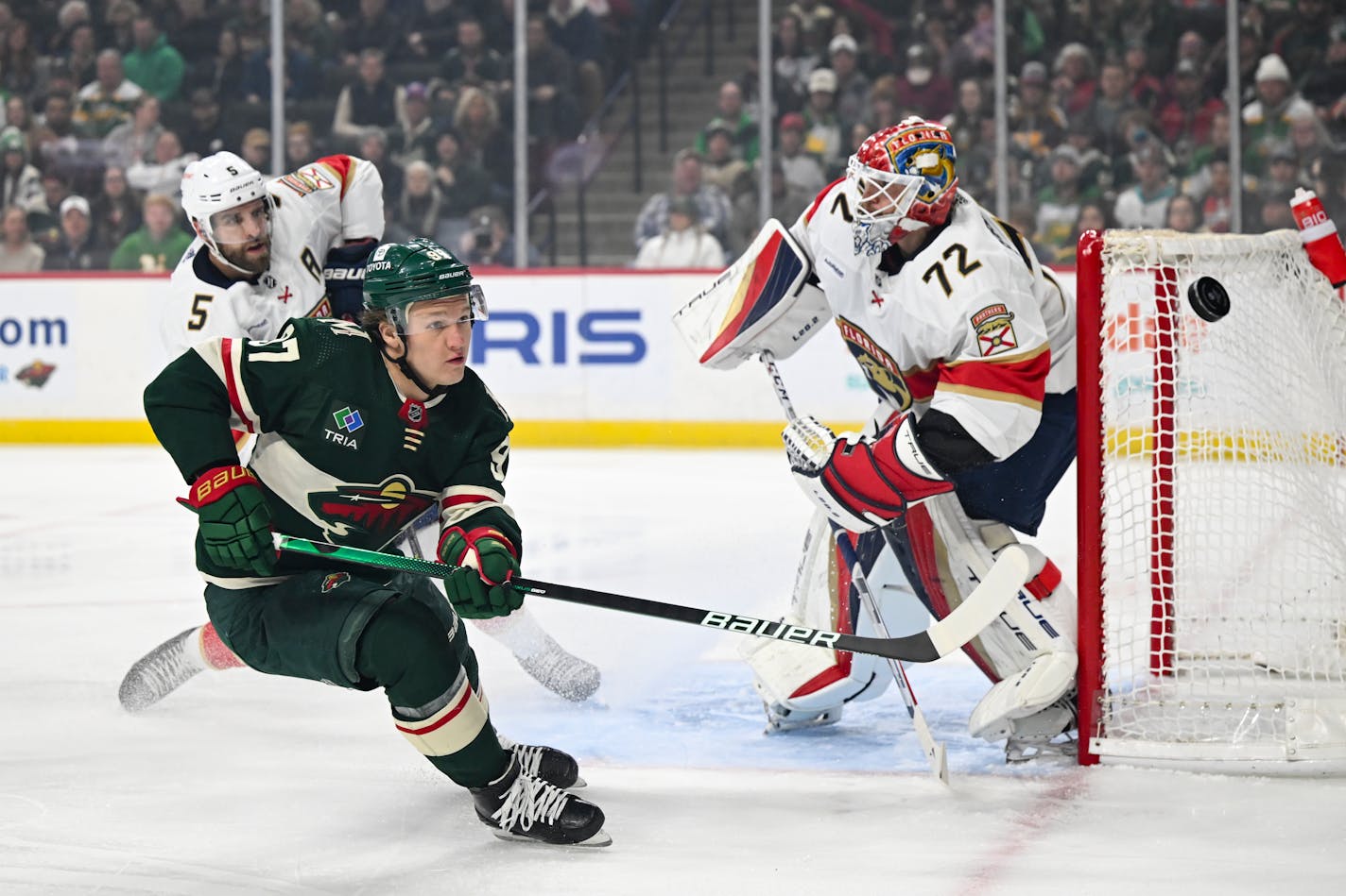 Minnesota Wild left wing Kirill Kaprizov (97) chases the puck into the corner while attacking the net against Florida Panthers goaltender Sergei Bobrovsky (72) during the first period of an NHL hockey game Monday, Feb. 13, 2023 at the Xcel Energy Center in St. Paul, Minn. ] AARON LAVINSKY • aaron.lavinsky@startribune.com