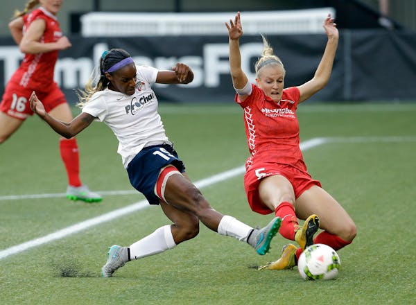 CORRECTS FINAL SCORE TO 3-3 FROM 2-2. Washington Spirit defender Crystal Dunn, left, takes a shot on goal as Portland Thorns defender Kat Williamson d