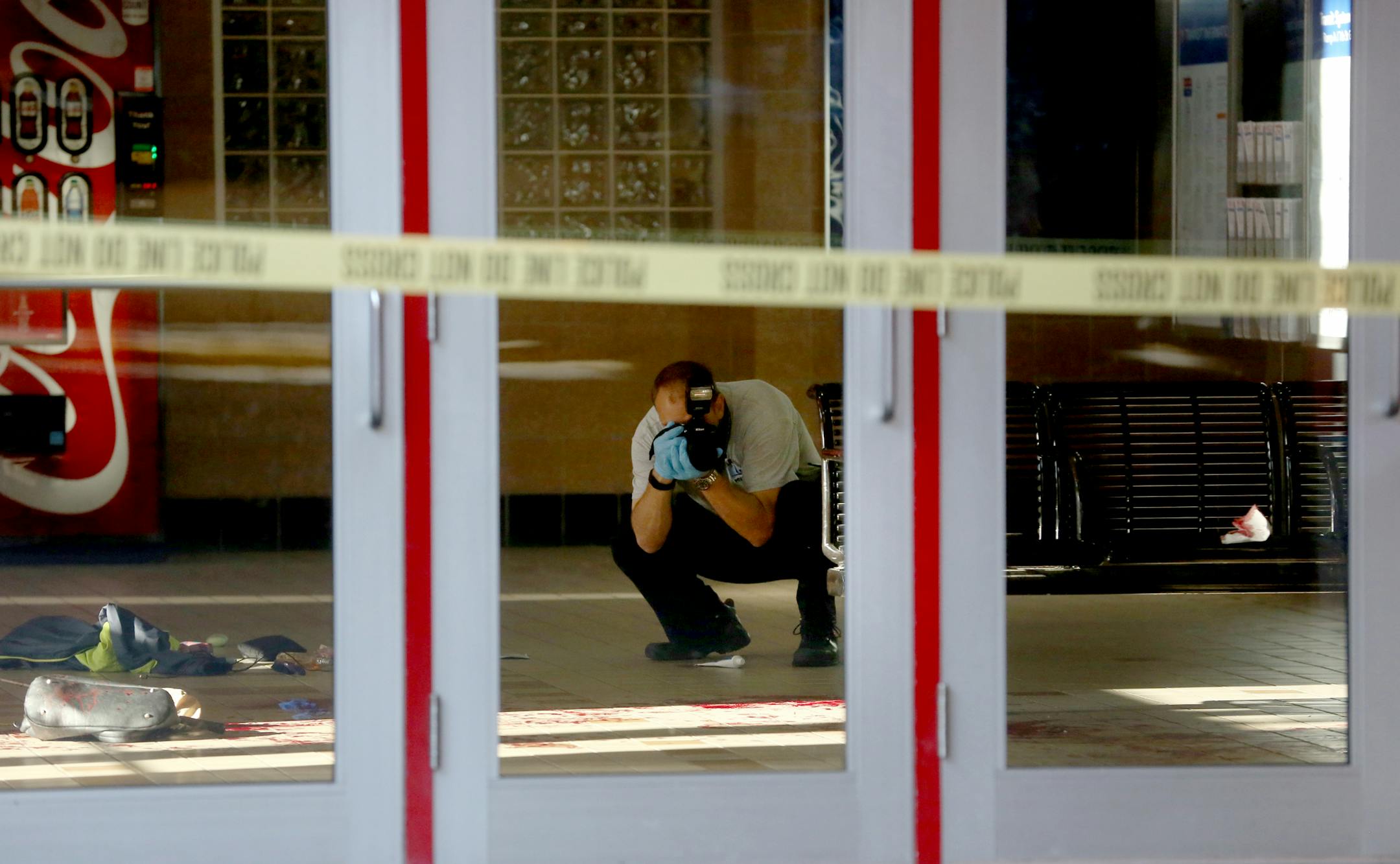 A Minneapolis medical examiner photographed the scene where a woman was stabbed by another. ] (KYNDELL HARKNESS/STAR TRIBUNE) kyndell.harkness@startribune.com A fatal stabbing between two women at the Ramp A transit station in Minneapolis, Min., Thursday, June 25, 2015.