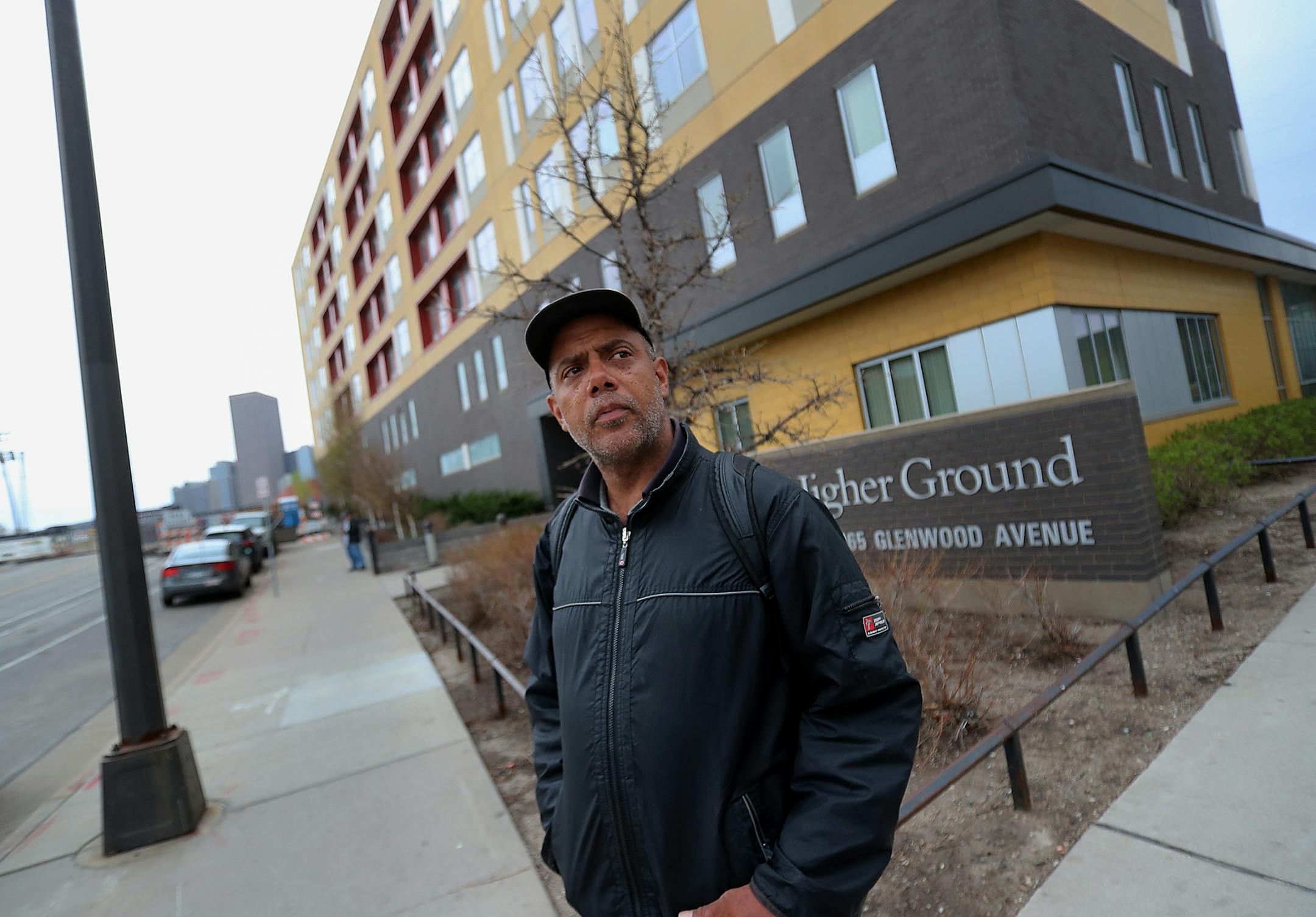 After moving out of the Higher Ground homeless shelter in Minneapolis Douglas Pyle, 49, looks down the street for a bus that will take him to his hotel room for the first time Friday, May 1, 2020, in Minneapolis, MN. Pyle is among more than 400 homeless people in Hennepin County who have been relocated to area hotels since the pandemic began. Pyle grew up in Indiana, spent a number of years in Florida and Madison, WI, before coming to Minneapolis 13 years ago and becoming homeless two years ago.