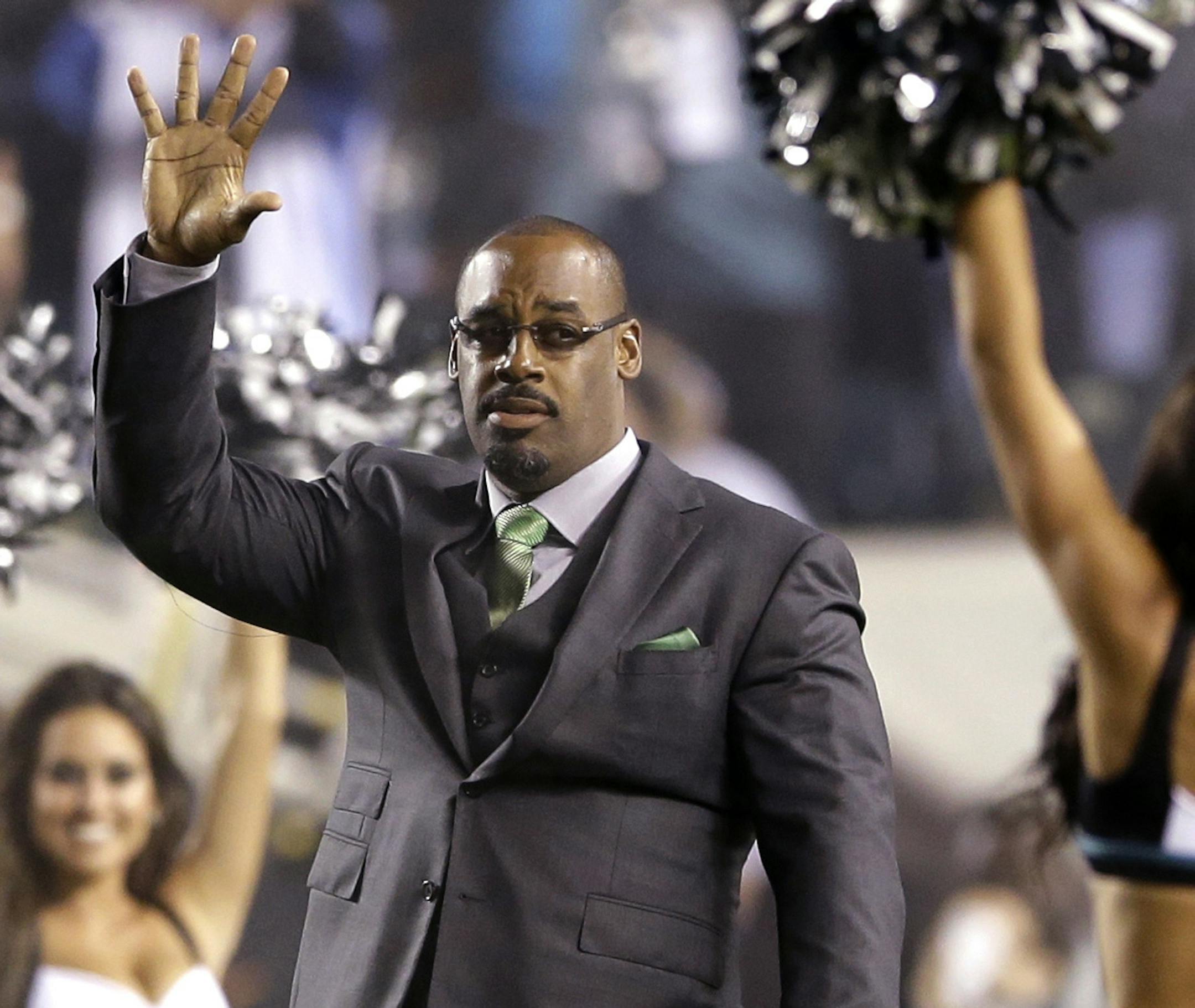 Former Philadelphia Eagles quarterback Donovan McNabb waves during halftime of an NFL football game between the Eagles and the Kansas City Chiefs, Thursday, Sept. 19, 2013, in Philadelphia. McNabb's jersey number was retired. (AP Photo/Matt Rourke)
