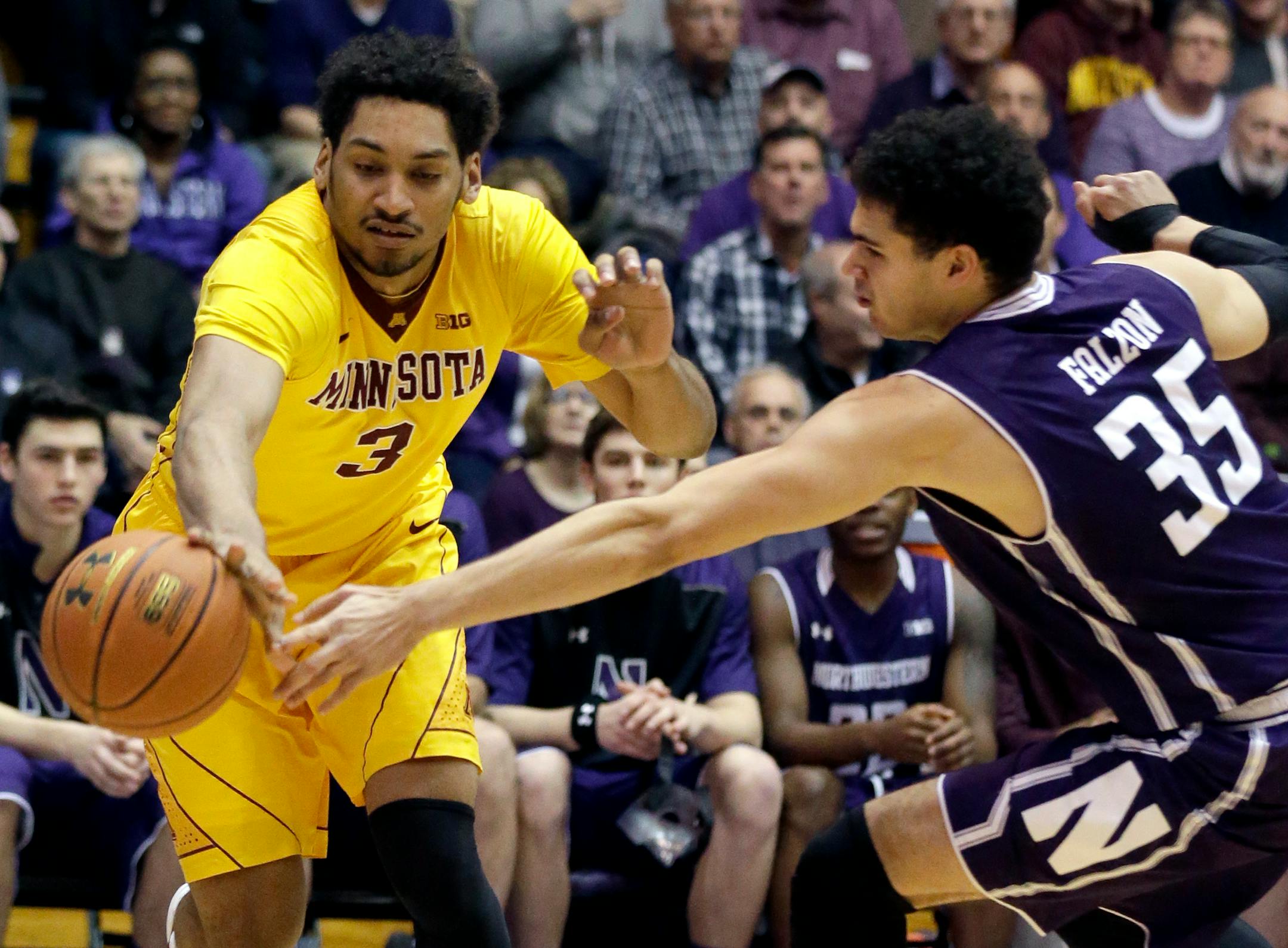 Minnesota forward Jordan Murphy, left, controls the ball against Northwestern forward Aaron Falzon during the first half of an NCAA college basketball game on Thursday, Feb. 4, 2016, in Evanston, Ill. (AP Photo/Nam Y. Huh)
