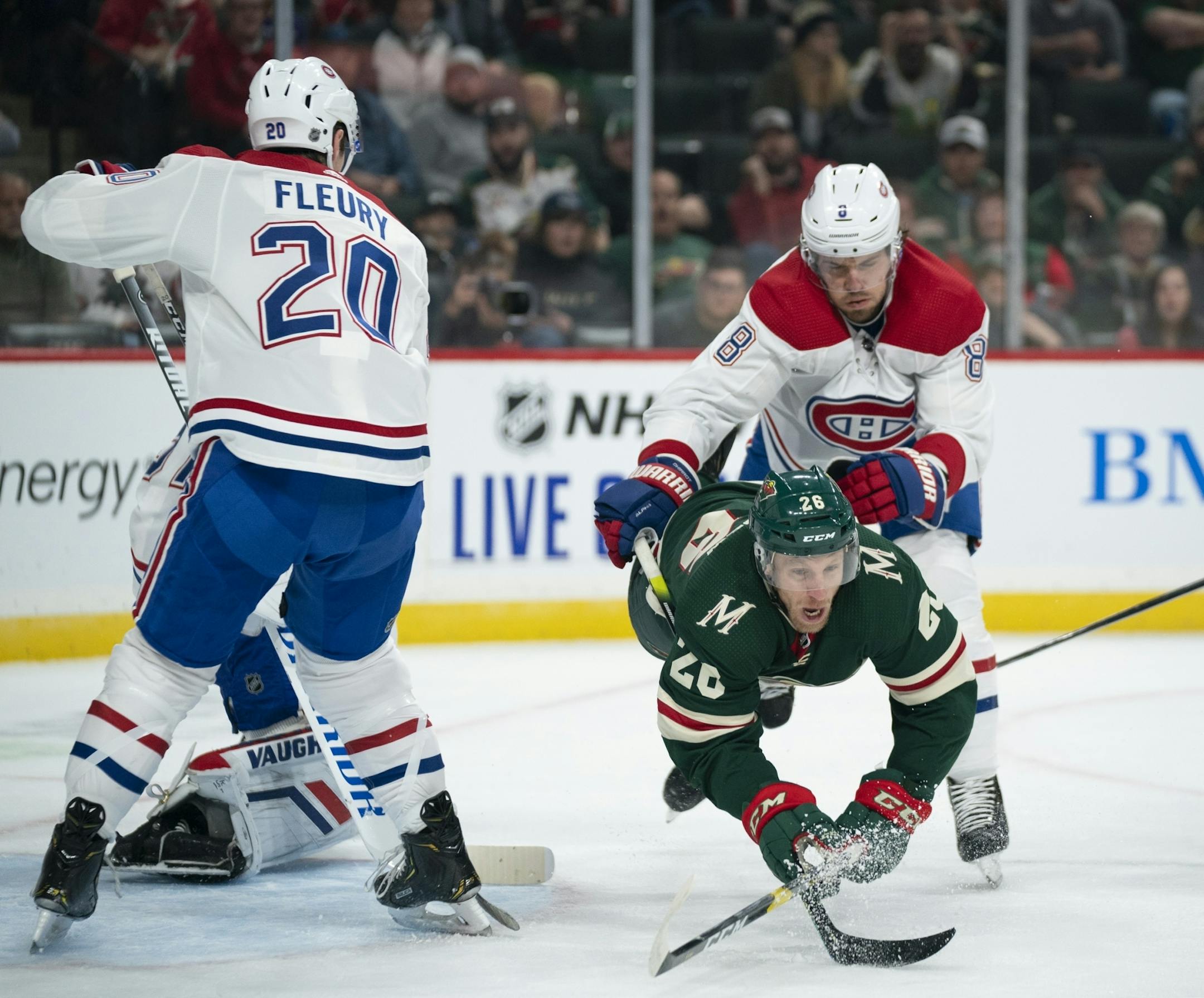 Minnesota Wild center Gerald Mayhew (26) was dumped in front of the net by Montreal Canadiens defenseman Ben Chiarot (8) in the first period.