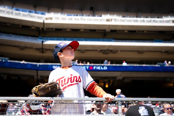 Ben Wozniak watches the Twins game Sunday against Detroit at Target Field. The Twins blocked off the top two levels of seats as an experiment this mon