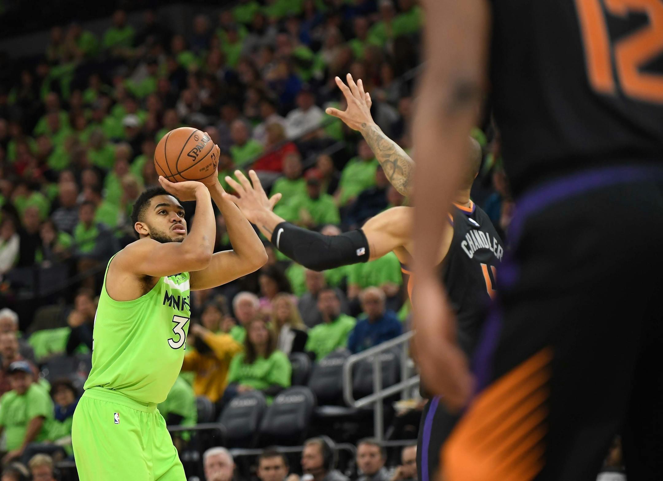 Minnesota Timberwolves center Karl-Anthony Towns (32) hit a three point shot over Phoenix Suns center Tyson Chandler (4) in the third quarter Saturday. ] AARON LAVINSKY ï aaron.lavinsky@startribune.com The Minnesota Timberwolves played the Phoenix Suns on Saturday, Dec. 16, 2017 at Target Center in Minneapolis, Minn.