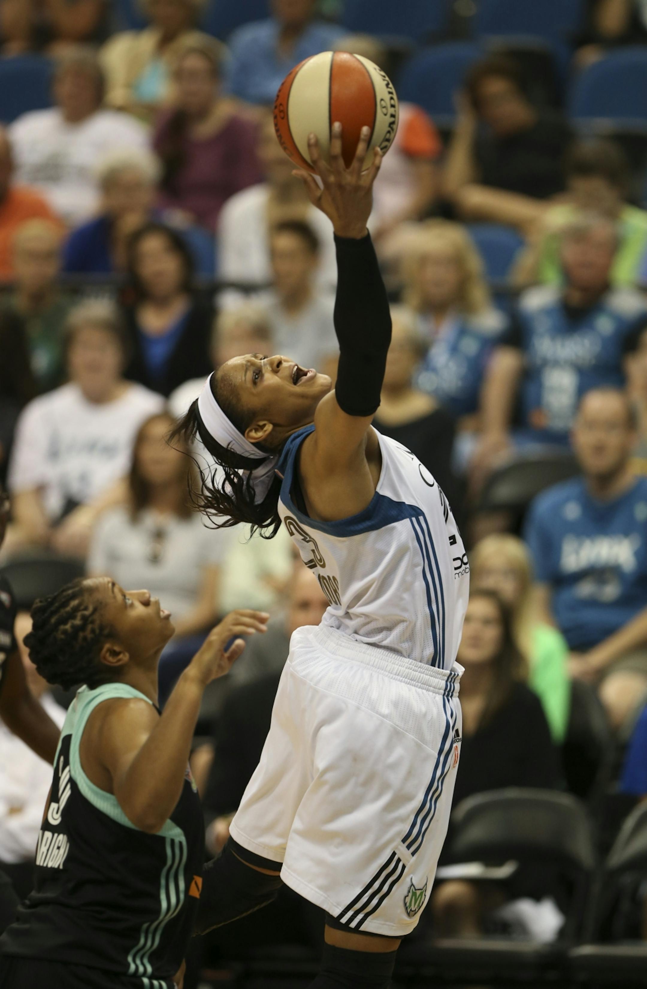Minnesota Lynx forward Maya Moore reached for a second quarter pass over New York Liberty guard Tanisha Wright Sunday night.