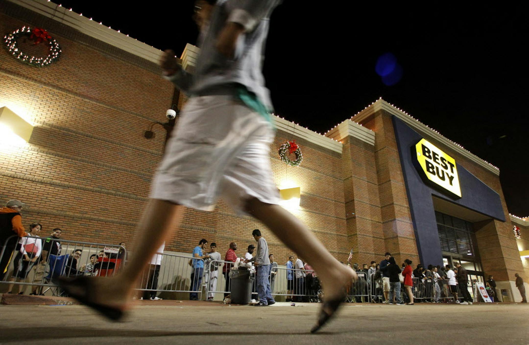 FILE - In this Thursday, Nov. 22, 2012, file photo, shoppers stand in line outside a Best Buy department store before the store's opening at midnight. Thanksgiving is slowly becoming just another shopping day as at least a dozen major retailers are planing to open Thursday, Nov. 28, 2013. (AP Photo/Tony Gutierrez, File)