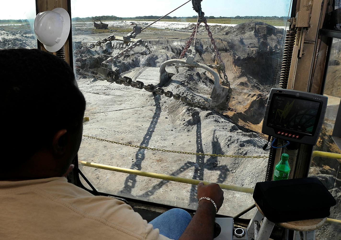 Mosaic Co. operator David Williams works the controls of a phosphate dragline in Tampa, Florida, U.S., on Friday, Dec. 2, 2011. Mosaic Co. is the world's largest producer of phosphate and second-largest producer of potash, two crop nutrients which are primary ingredients in producing fertilizer. Photographer: Jim Stem/Bloomberg *** Local Caption *** David Williams